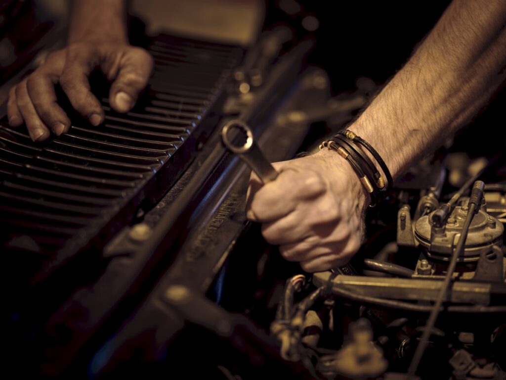 Roadside battery and alternator electrical diagnosis under the hood of a car